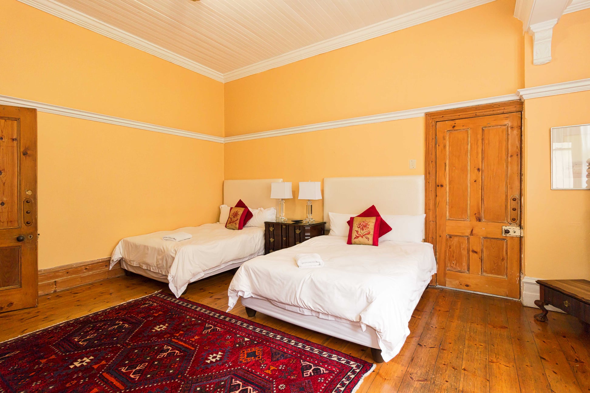 Classic twin room with red accent pillows